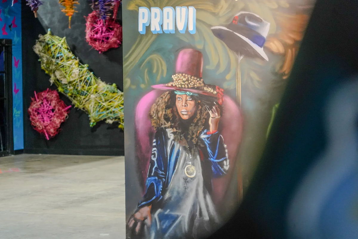Portrait painting beside suspended sculpture inside Gallery DeFi