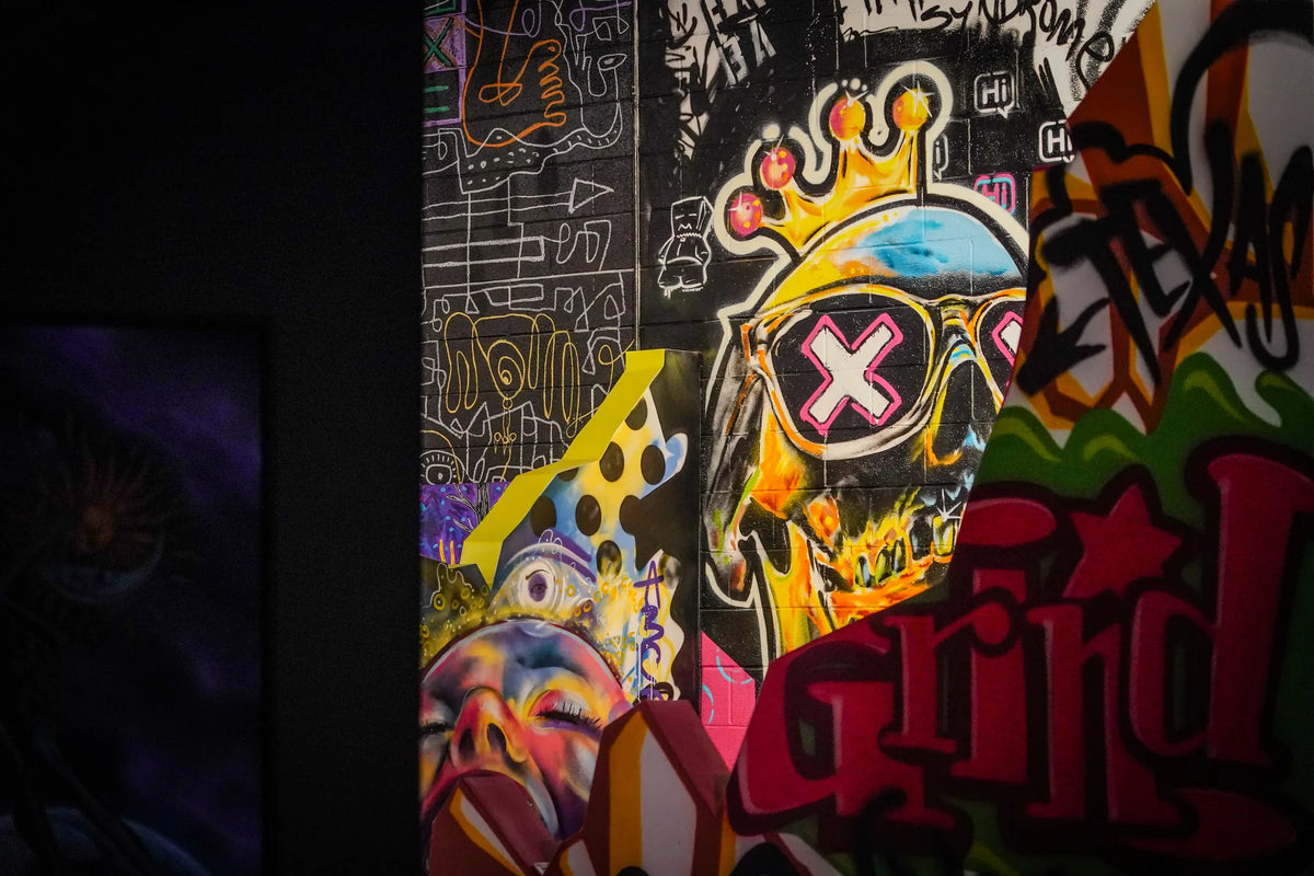 Crowned skull and lettering painted across a mural at Gallery DeFi