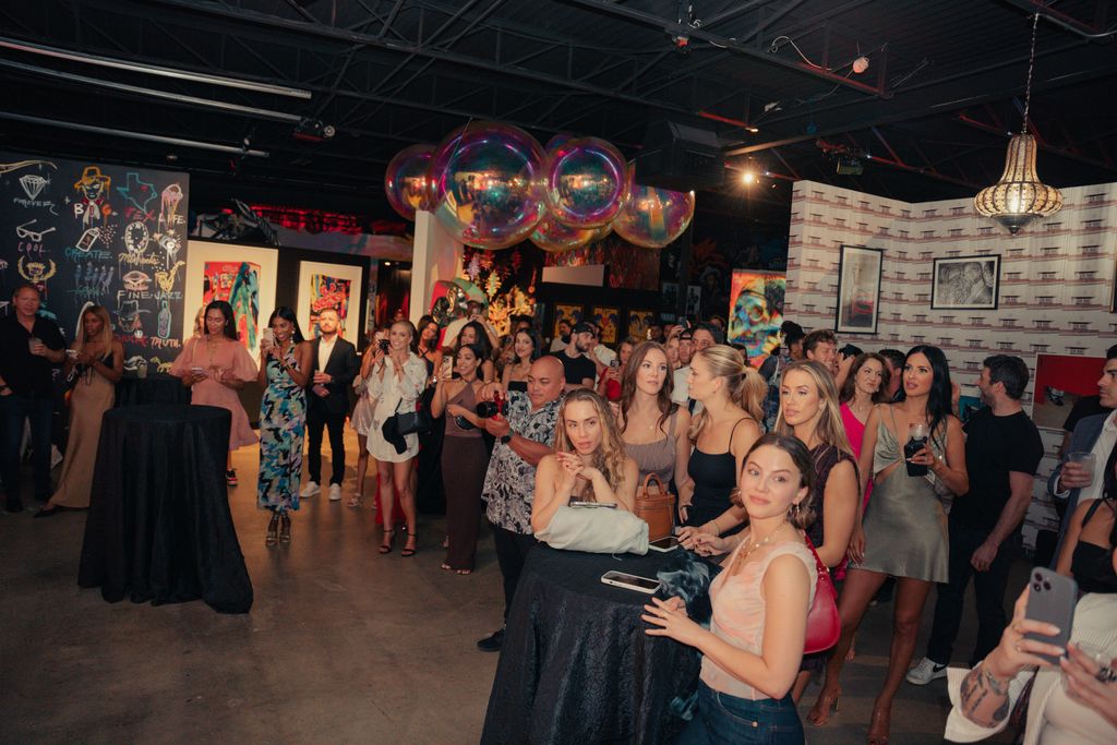 A full crowd gathered for an art and culture event inside Gallery DeFi