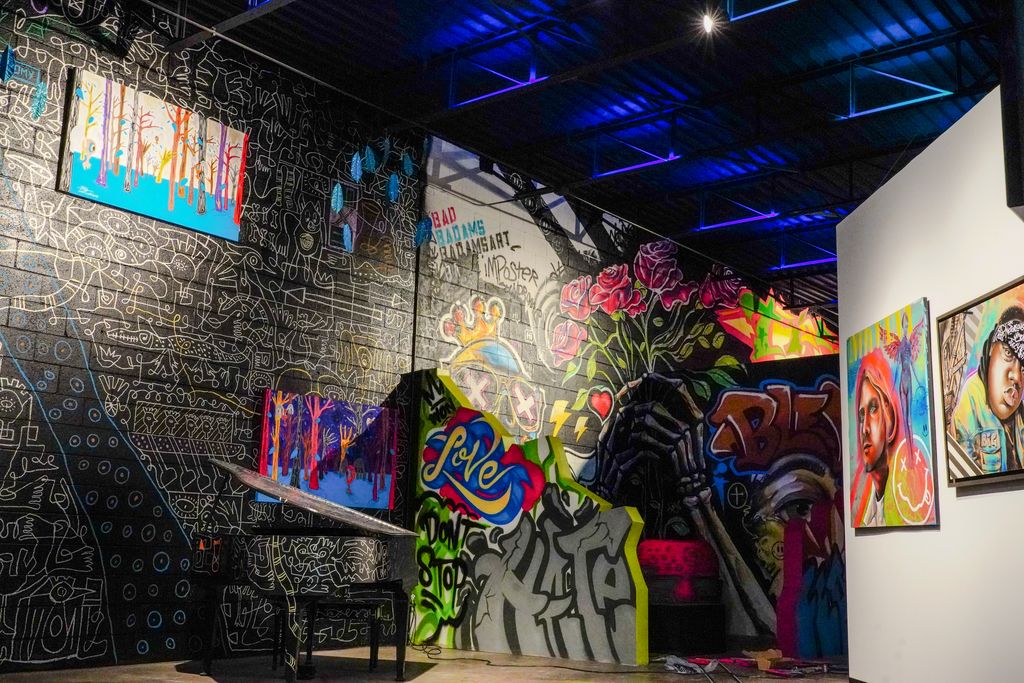 Wide immersive mural room inside Gallery DeFi in West Dallas