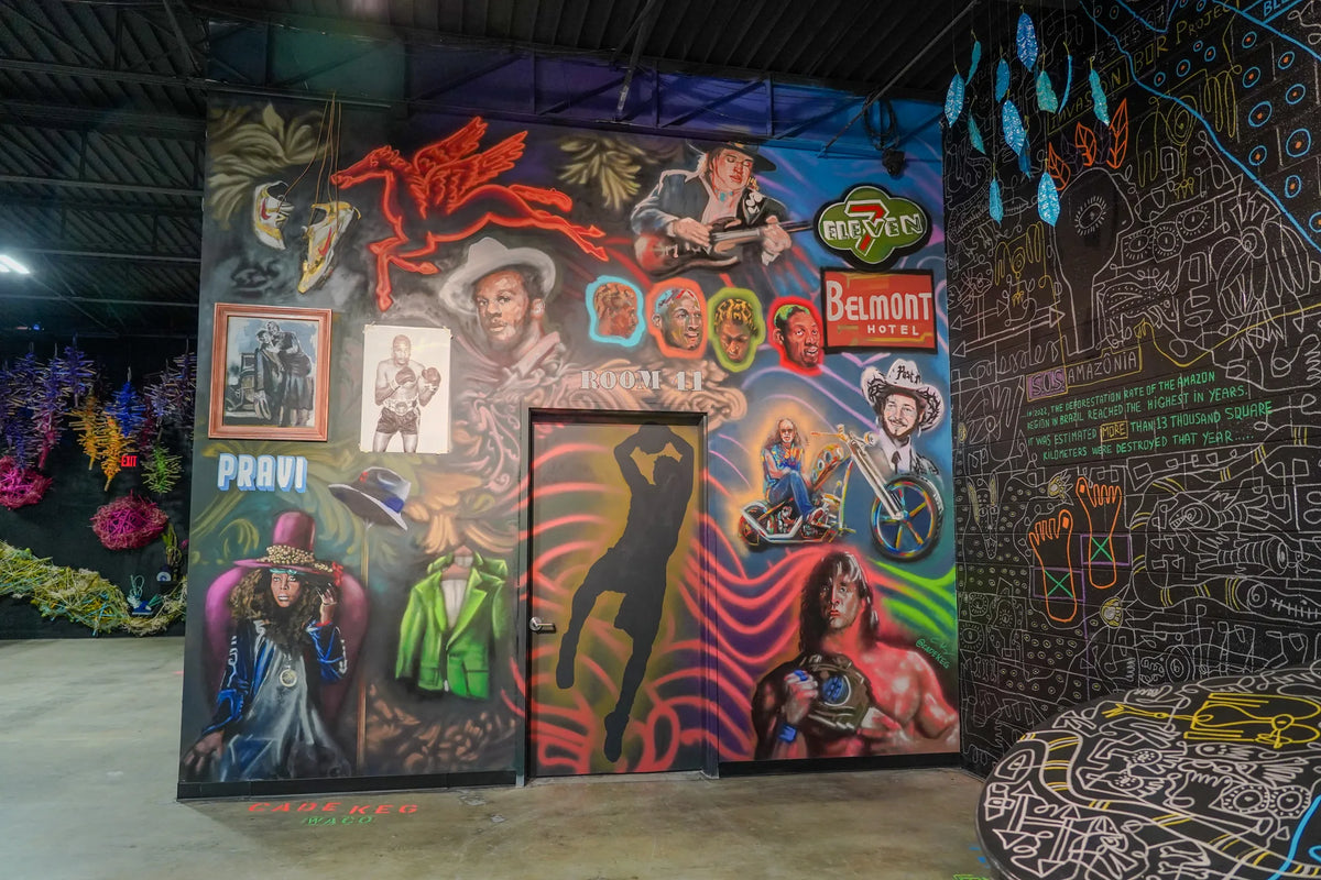 Murals and paintings across a gallery wall at Gallery DeFi